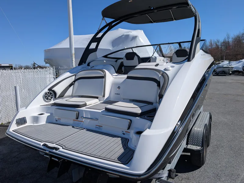 Slide: The Image of 2019 Yamaha Boats 242 Limited S, sleek design, spacious seating, on trailer, outdoor display. - 8