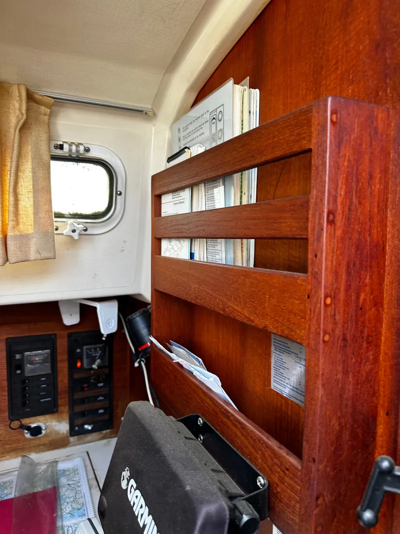 Slide: The Image of Interior of 1985 Sabre 32 Aft Cabin with wooden paneling and navigation equipment. - 10