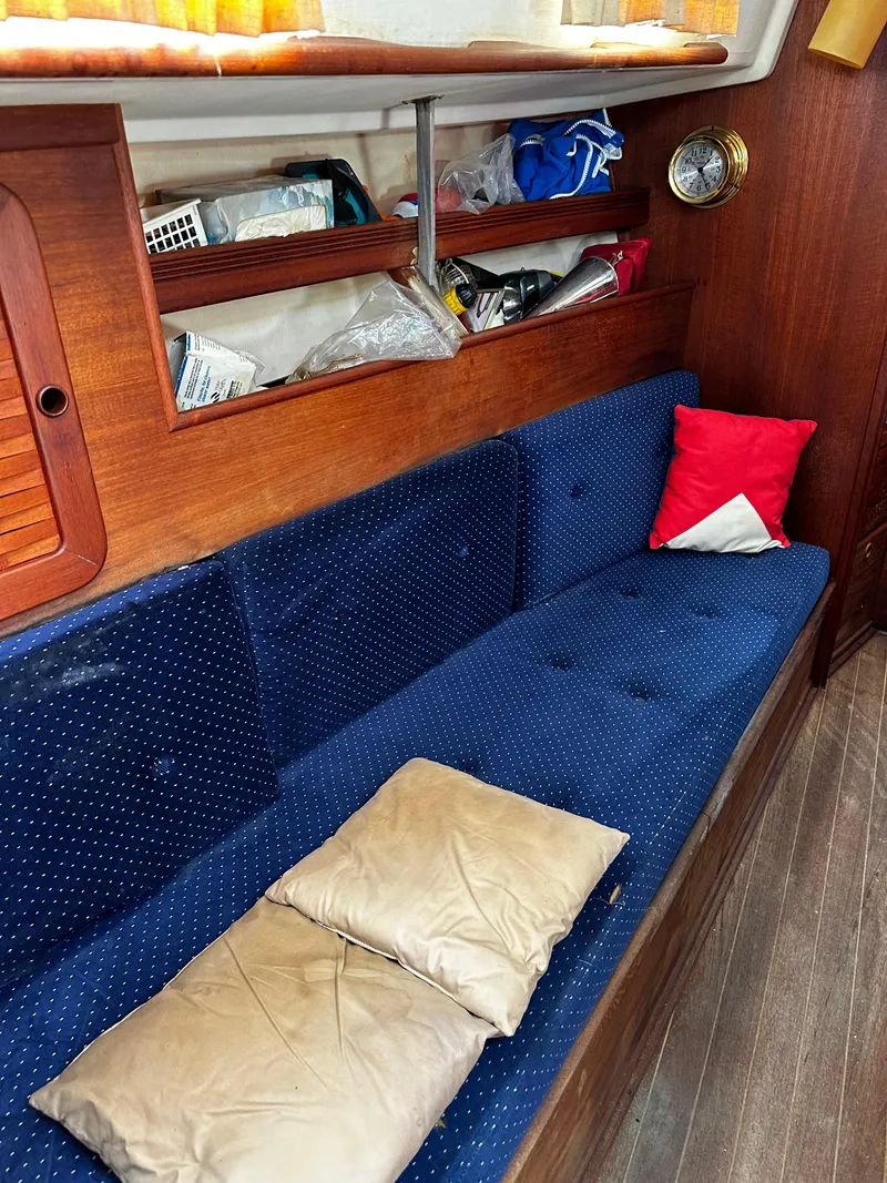 Slide: The Image of Interior of 1985 Sabre 32 Aft Cabin with blue seating and wooden accents. - 13