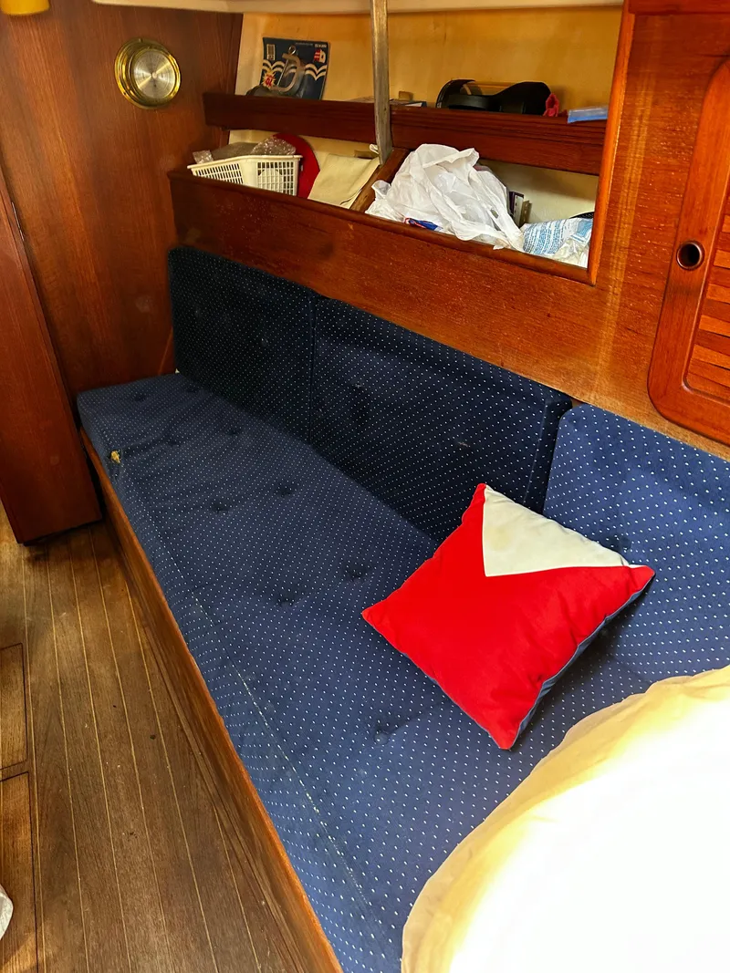 Slide: The Image of 1985 Sabre 32 Aft Cabin interior with blue sofa and red pillow. - 15