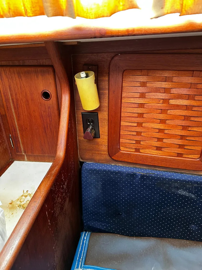 Slide: The Image of 1985 Sabre 32 Aft Cabin interior with wood paneling and woven cabinet door. - 17