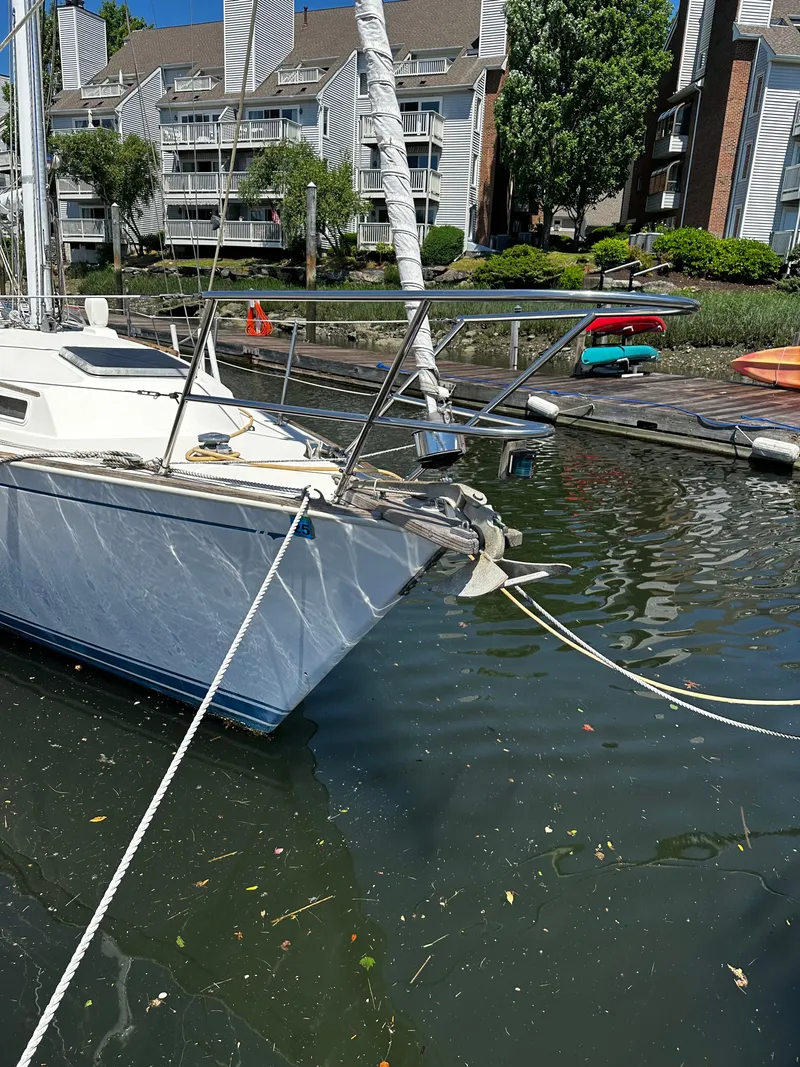 Slide: The Image of 1985 Sabre 32 Aft Cabin sailboat docked in a marina with waterfront buildings. - 19