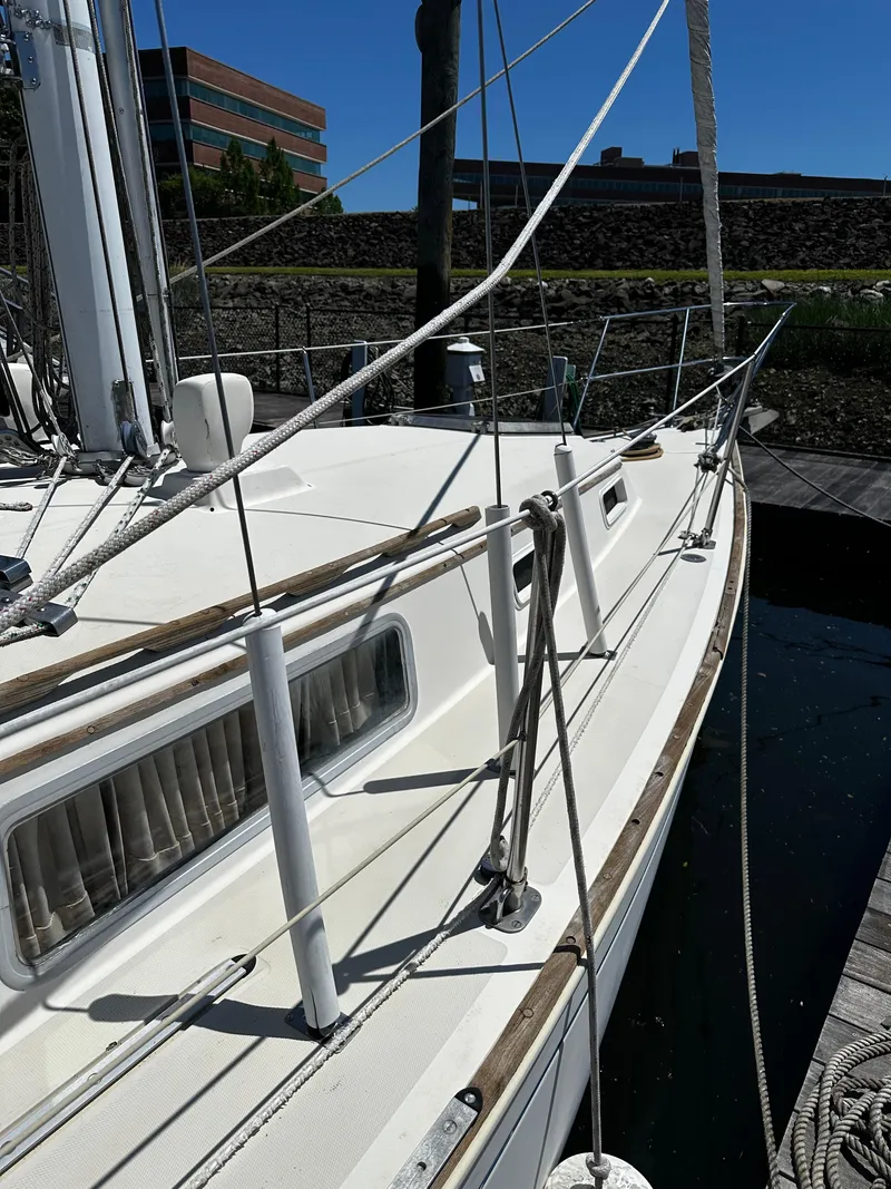 Slide: The Image of 1985 Sabre 32 Aft Cabin sailboat docked, showcasing deck and rigging details. - 2