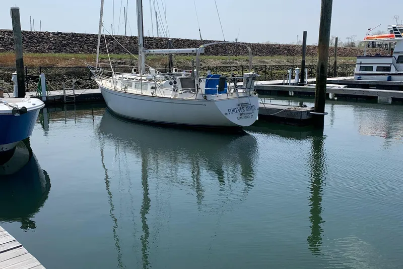 Slide: The Image of 1985 Sabre 32 Aft Cabin sailboat docked in a calm marina. - 4