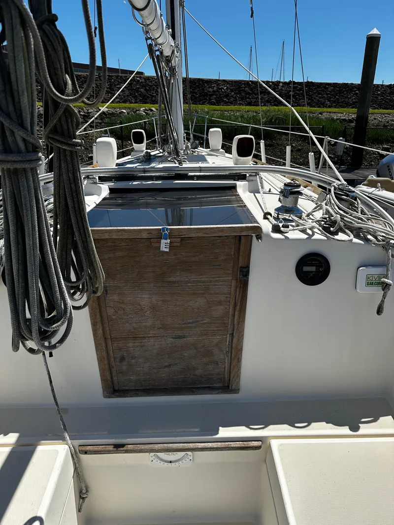 Slide: The Image of 1985 Sabre 32 Aft Cabin sailboat deck with rigging and wooden hatch. - 8