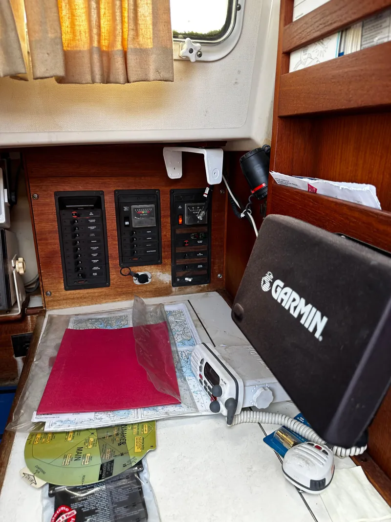 Slide: The Image of Navigation station in 1985 Sabre 32 Aft Cabin with Garmin equipment and charts. - 9