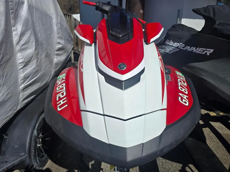 Slide: The Image of 2021 Yamaha WaveRunner FX Cruiser SVHO in red and white, parked outdoors. - 1