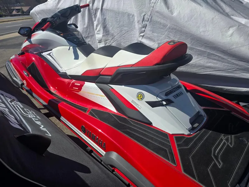 Slide: The Image of 2021 Yamaha WaveRunner FX Cruiser SVHO in red and white, parked outdoors. - 2