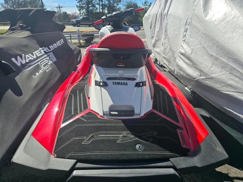 Slide: The Image of 2021 Yamaha WaveRunner FX Cruiser SVHO in red and white, parked outdoors. - 4