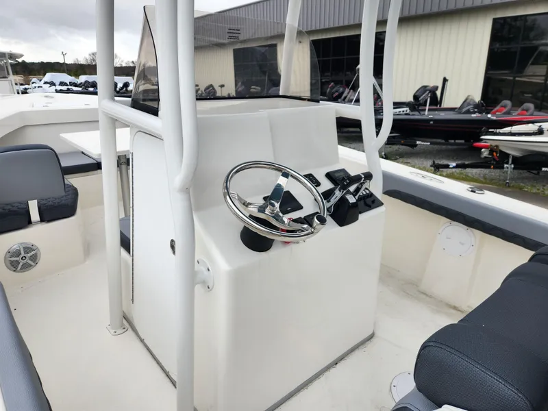 Slide: The Image of 2025 May-Craft 245 Offshore CC boat console with steering wheel and controls. - 12