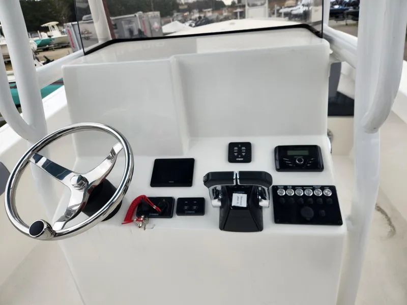 Slide: The Image of 2025 May-Craft 245 Offshore CC helm with steering wheel and control panel. - 14