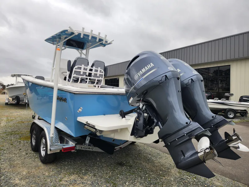 Slide: The Image of 2025 May-Craft 245 Offshore CC boat with dual Yamaha engines, parked on a trailer. - 4