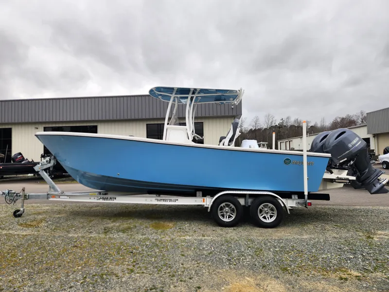 Slide: The Image of 2025 May-Craft 245 Offshore CC boat on trailer, blue hull, dual engines, overcast day. - 6