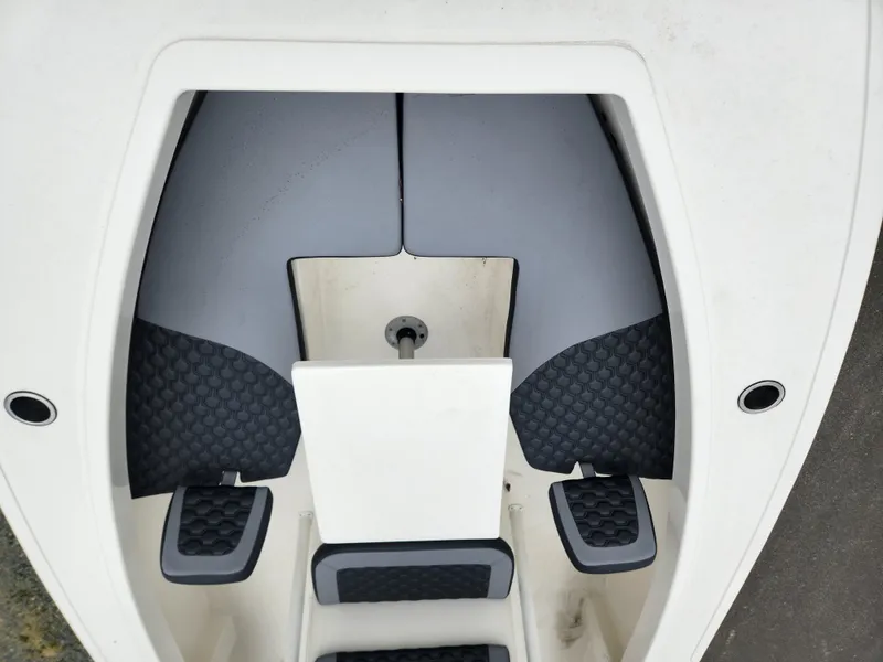 Slide: The Image of 2025 May-Craft 245 Offshore CC boat interior with cushioned seating and storage compartments. - 8