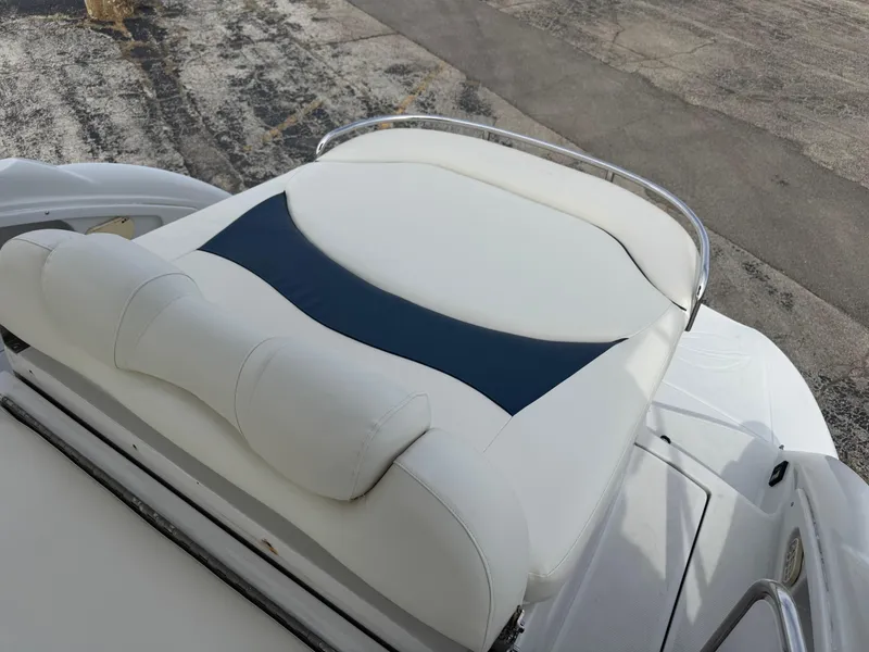 Slide: The Image of 2008 Crownline 315 SCR boat with white and blue cushioned seating. - 10