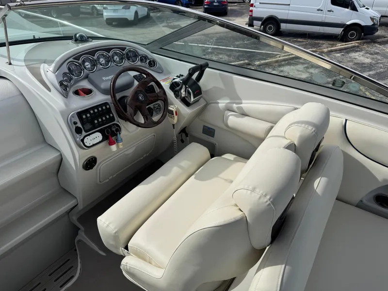 Slide: The Image of 2008 Crownline 315 SCR boat cockpit with steering wheel and control panel. - 11