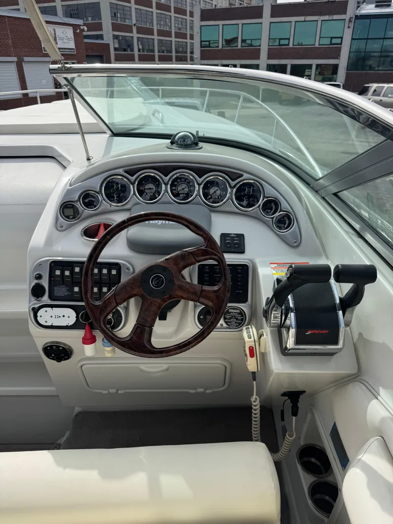 Slide: The Image of 2008 Crownline 315 SCR boat dashboard with steering wheel and control panel. - 12