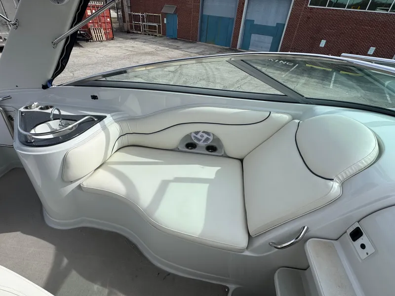 Slide: The Image of 2008 Crownline 315 SCR boat interior with white seating and built-in sink. - 15