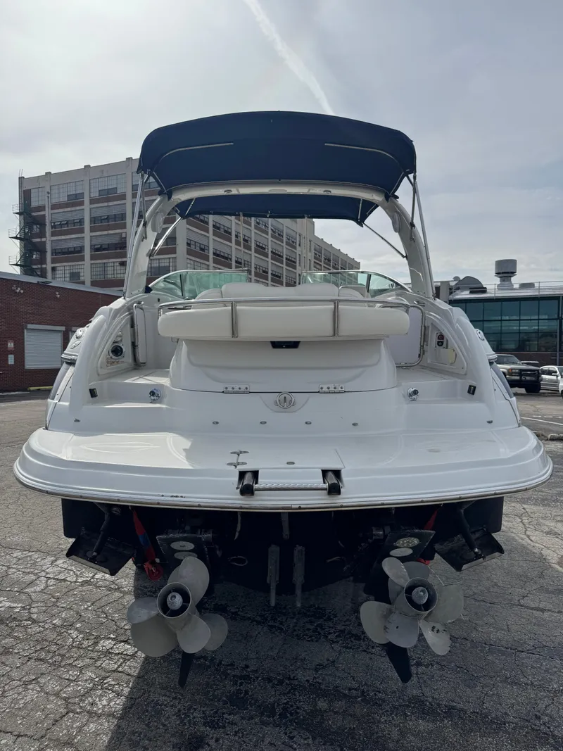 Slide: The Image of 2008 Crownline 315 SCR boat, rear view with dual propellers, parked outdoors. - 2