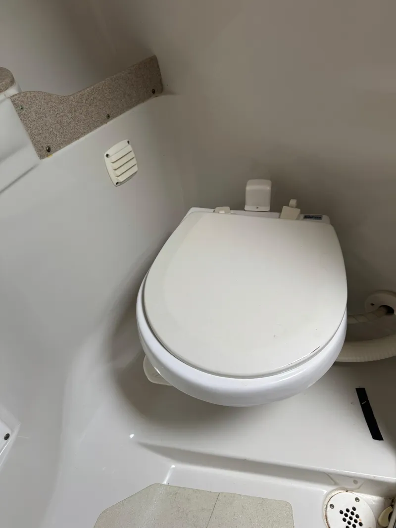 Slide: The Image of 2008 Crownline 315 SCR boat bathroom with white toilet and compact design. - 22