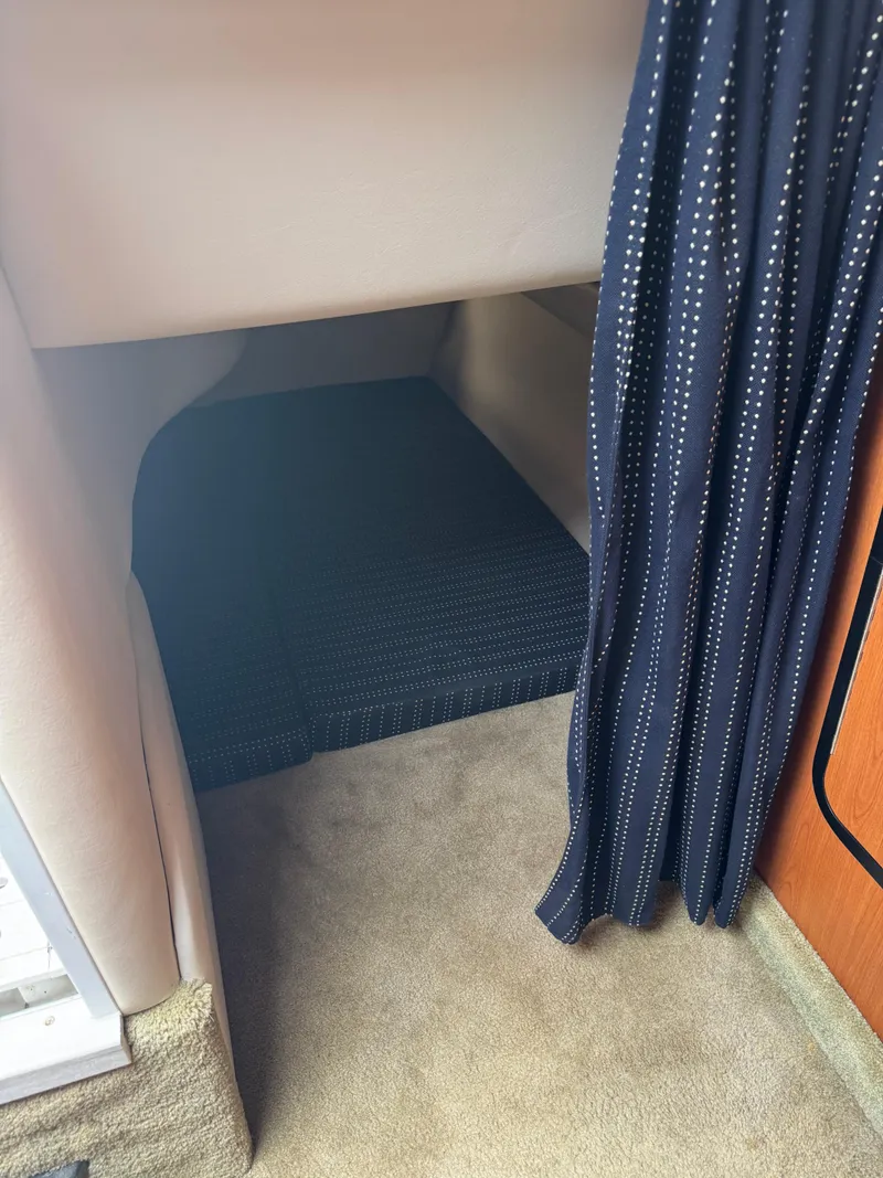 Slide: The Image of 2008 Crownline 315 SCR cabin interior with carpet and curtain. - 24