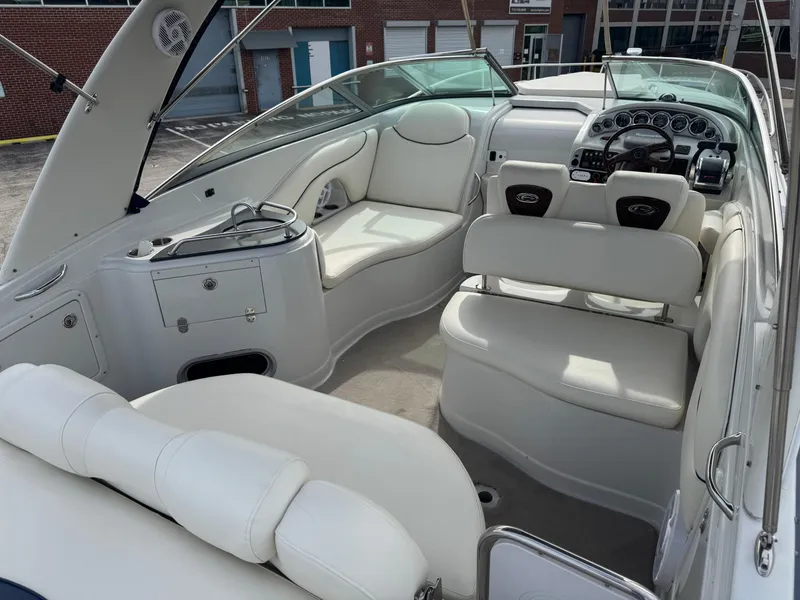 Slide: The Image of 2008 Crownline 315 SCR boat interior with white seating and modern dashboard. - 6