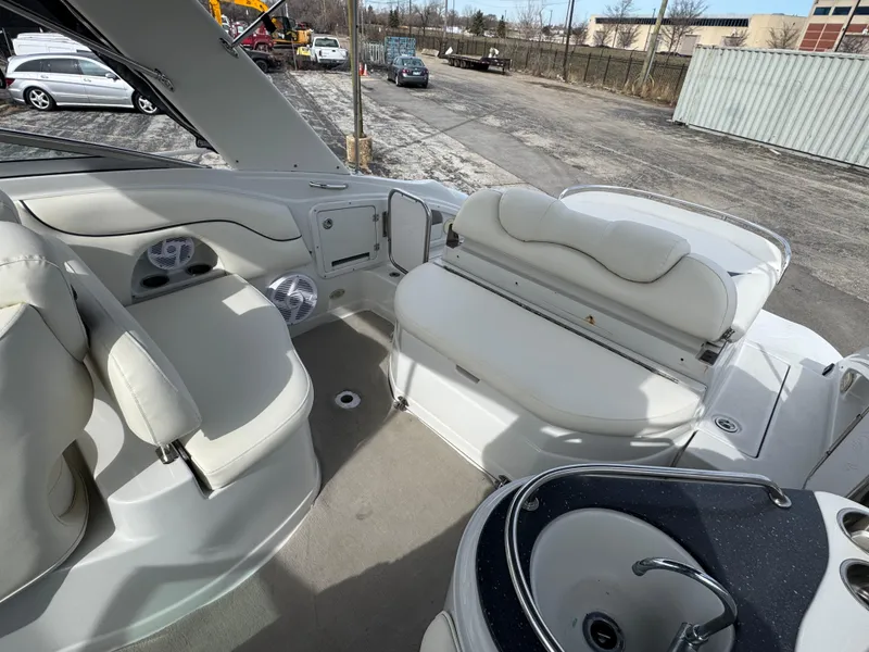 Slide: The Image of 2008 Crownline 315 SCR boat interior with white seating and sink. - 9