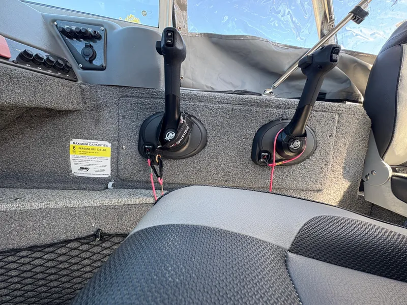 Slide: The Image of 2017 Lund 1800 Sport Angler interior with control levers and seating. - 14