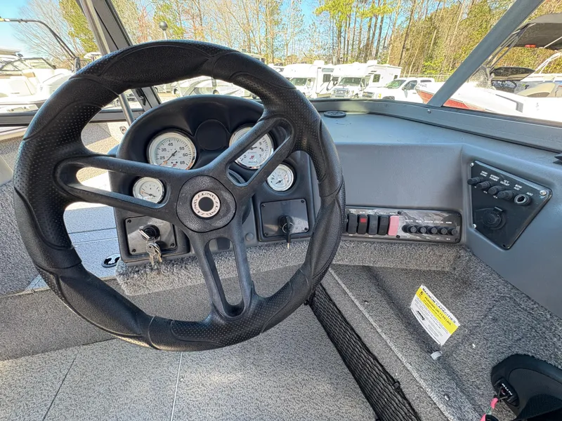 Slide: The Image of 2017 Lund 1800 Sport Angler dashboard with steering wheel and instrument panel. - 15