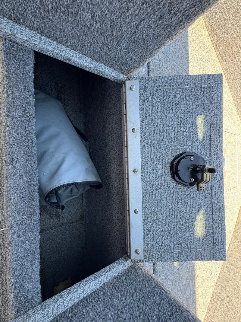 Slide: The Image of Open storage compartment in 2017 Lund 1800 Sport Angler boat, showing interior. - 19