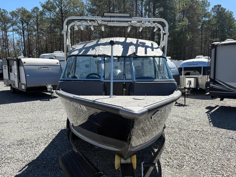 Slide: The Image of 2017 Lund 1800 Sport Angler boat on trailer, parked in a lot with RVs. - 6
