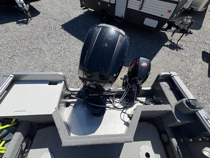 Slide: The Image of 2017 Lund 1800 Sport Angler boat with dual outboard motors, parked on gravel. - 8