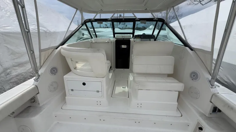 Slide: The Image of 2005 Tiara Yachts 2900 Open interior with white seating and helm station. - 12