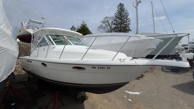 Slide: The Image of 2005 Tiara Yachts 2900 Open boat on dry dock, white hull, outdoor setting. - 2