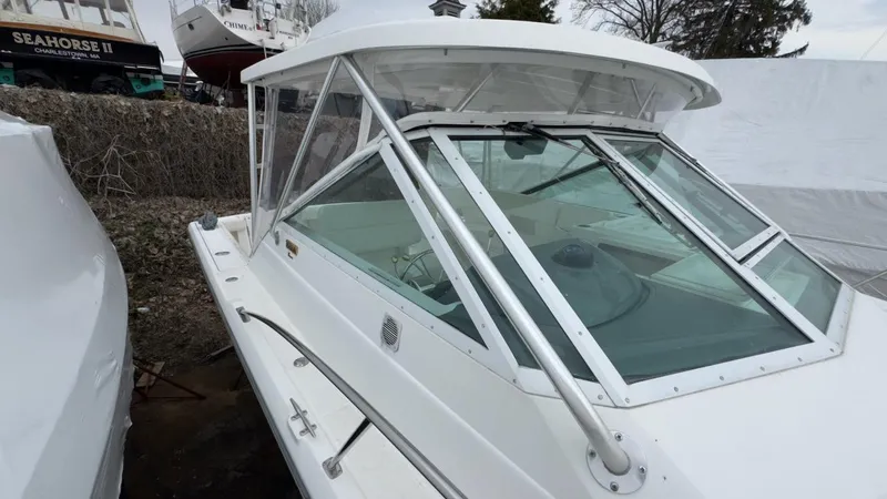 Slide: The Image of 2005 Tiara Yachts 2900 Open boat with sleek white exterior and spacious cabin. - 5