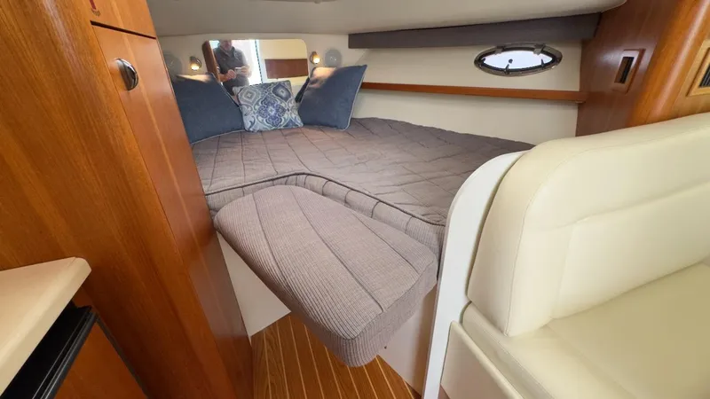 Slide: The Image of 2005 Tiara Yachts 2900 Open cabin interior with cozy bed and wooden accents. - 36