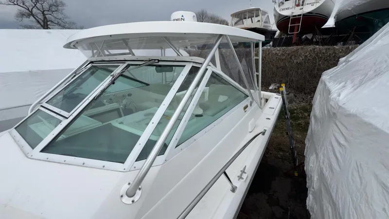 Slide: The Image of 2005 Tiara Yachts 2900 Open boat, white exterior, docked outdoors. - 4