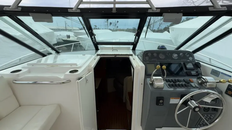 Slide: The Image of 2005 Tiara Yachts 2900 Open cockpit with steering wheel and control panel. - 22
