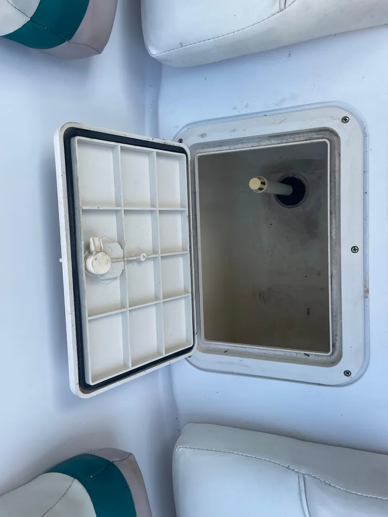 Slide: The Image of Open storage compartment on a 2000 Hurricane SunDeck 237 OB boat. - 3