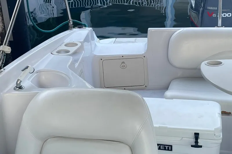 Slide: The Image of 2000 Hurricane SunDeck 237 OB boat interior with seating and storage compartments. - 9