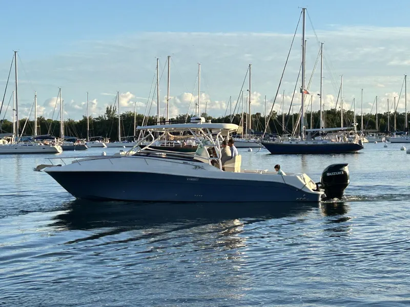 Slide: The Image of 2007 Hydra-Sports 2900 VX boat cruising in a marina with sailboats in the background. - 10