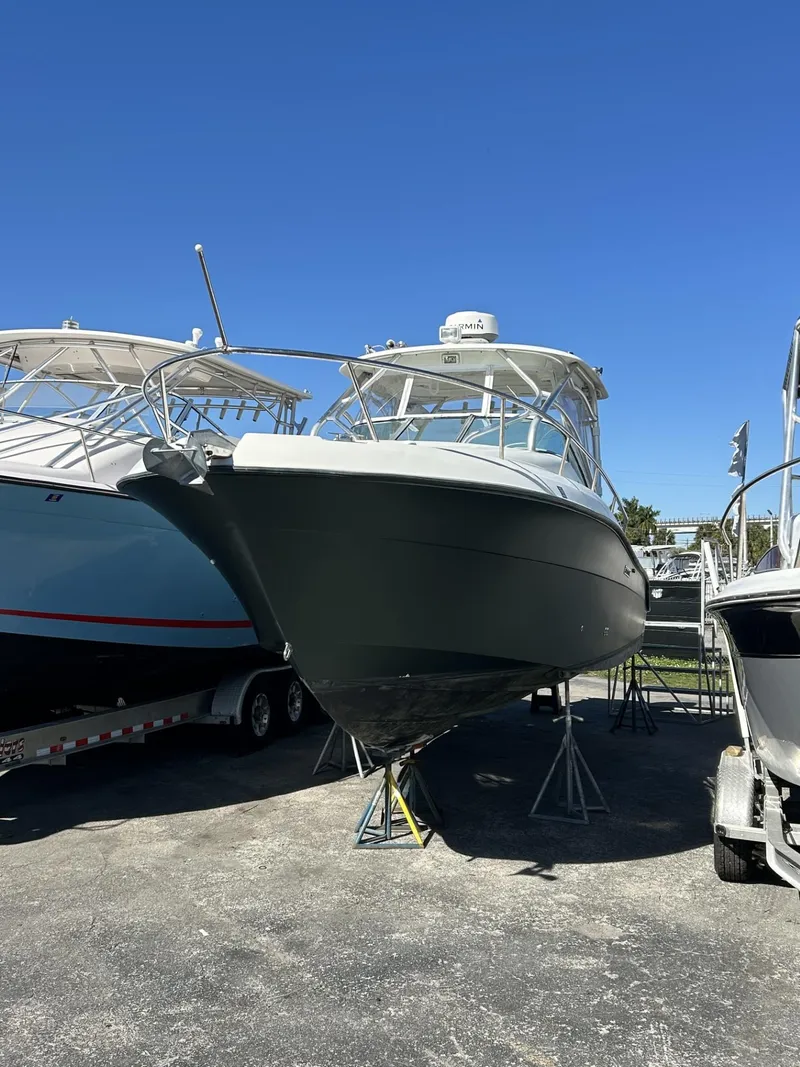 Slide: The Image of 2007 Hydra-Sports 2900 VX boat on stands, displayed outdoors under clear blue sky. - 11