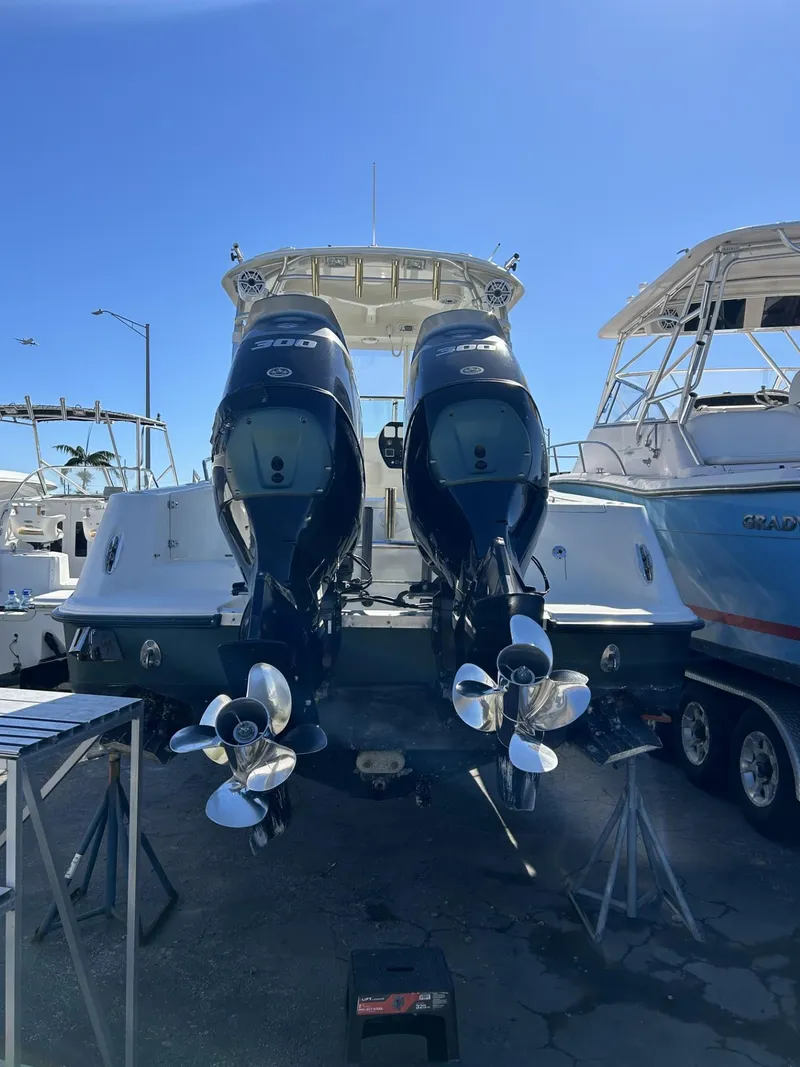 Slide: The Image of 2007 Hydra-Sports 2900 VX boat with dual outboard engines, docked under clear blue sky. - 13