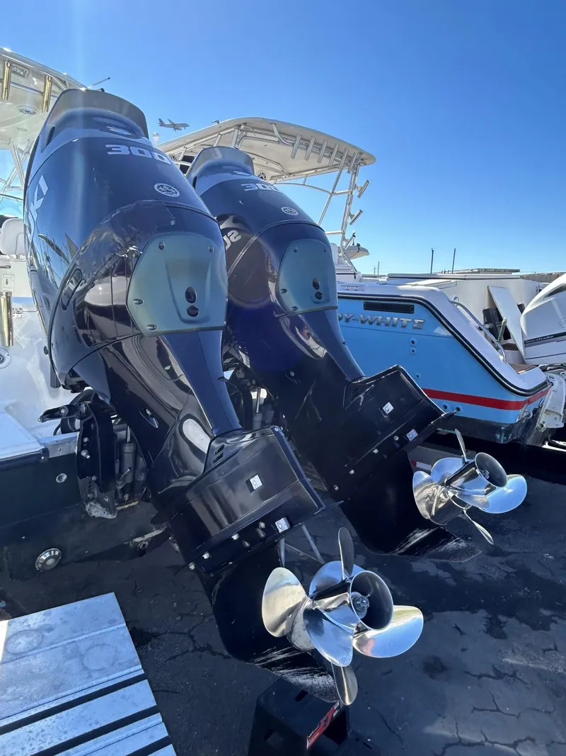 Slide: The Image of 2007 Hydra-Sports 2900 VX boat with dual outboard engines, docked under clear blue sky. - 14