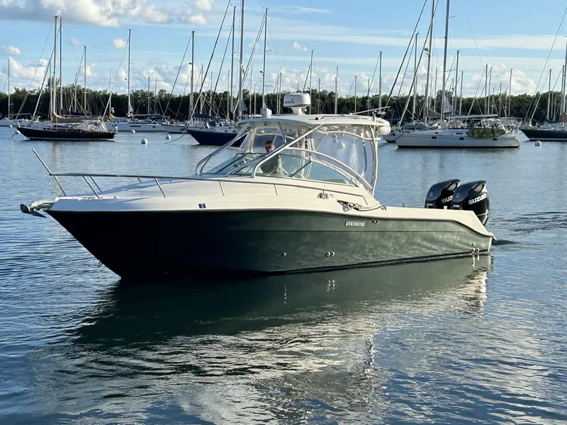 Slide: The Image of 2007 Hydra-Sports 2900 VX boat on calm water with sailboats in the background. - 2