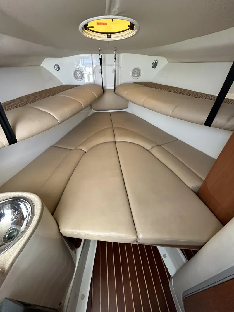 Slide: The Image of 2007 Hydra-Sports 2900 VX cabin interior with beige seating and wood flooring. - 24