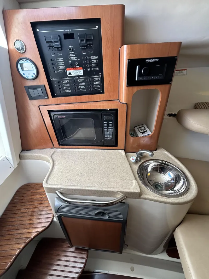 Slide: The Image of 2007 Hydra-Sports 2900 VX cabin with control panel, microwave, sink, and seating area. - 25