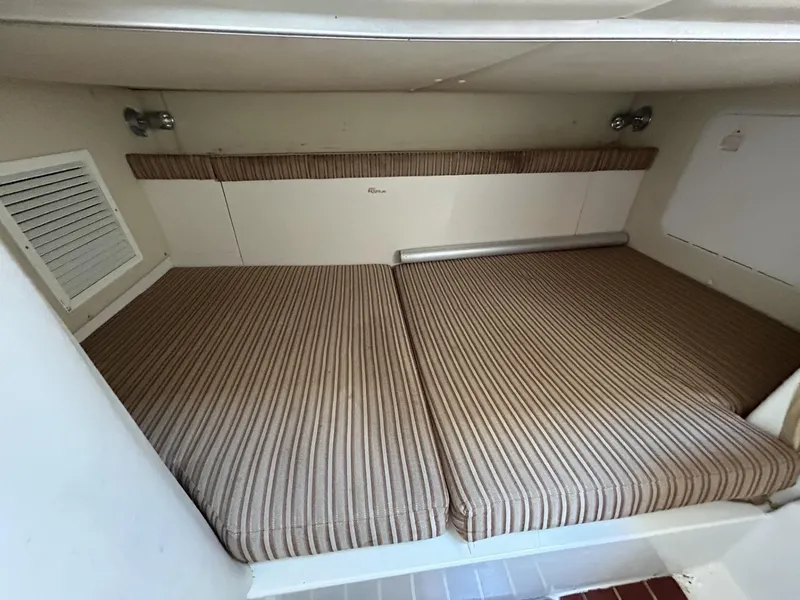 Slide: The Image of 2007 Hydra-Sports 2900 VX cabin interior with striped cushions and compact design. - 26