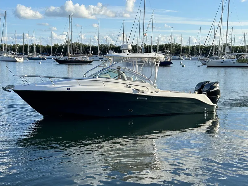 Slide: The Image of 2007 Hydra-Sports 2900 VX boat on calm water with sailboats in the background. - 3