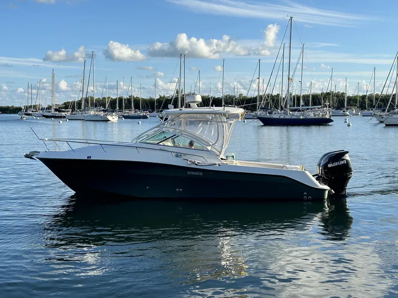 Slide: The Image of 2007 Hydra-Sports 2900 VX boat on calm water with sailboats in the background. - 4